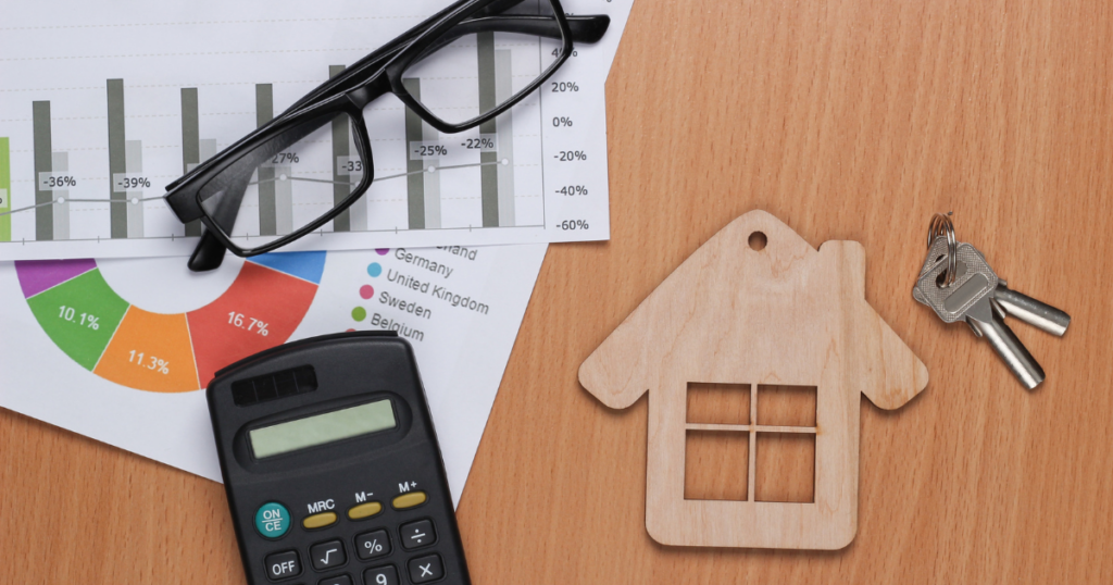 A table top with several items related to real estate, finance, and retrospective appraisals.